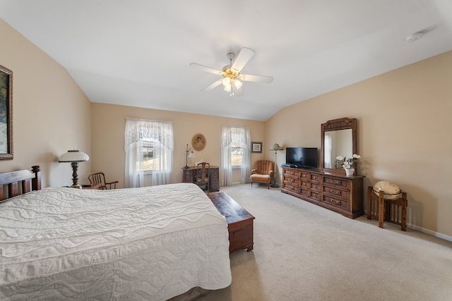 carpeted bedroom featuring a ceiling fan, lofted ceiling, and baseboards