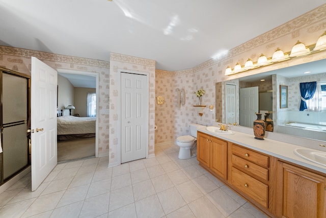 bathroom with double vanity, wallpapered walls, toilet, a sink, and tile patterned floors