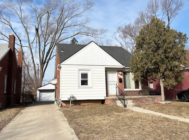 view of front of home with an outbuilding, a shingled roof, and a garage