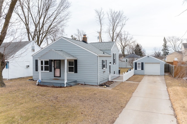 bungalow-style house with an outbuilding, driveway, a shingled roof, and fence