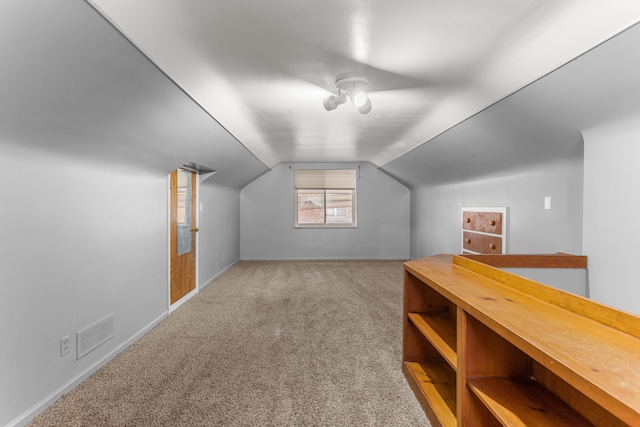 bonus room with lofted ceiling, carpet floors, visible vents, and baseboards