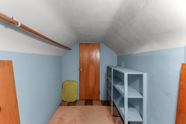 additional living space featuring vaulted ceiling and a textured ceiling