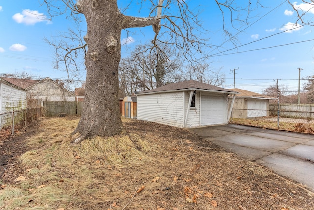 exterior space featuring concrete driveway and fence