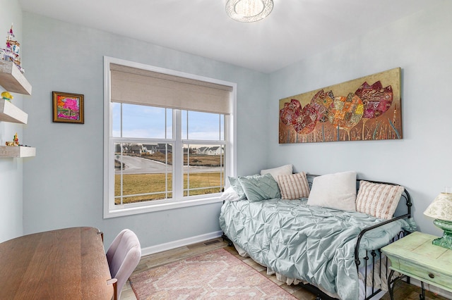 bedroom featuring baseboards and wood finished floors