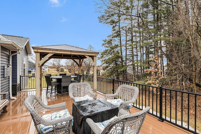 deck with a gazebo and outdoor dining space