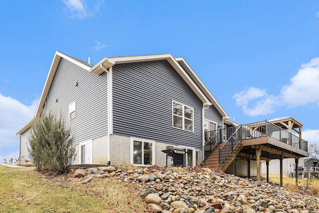 view of side of property with a deck and stairs