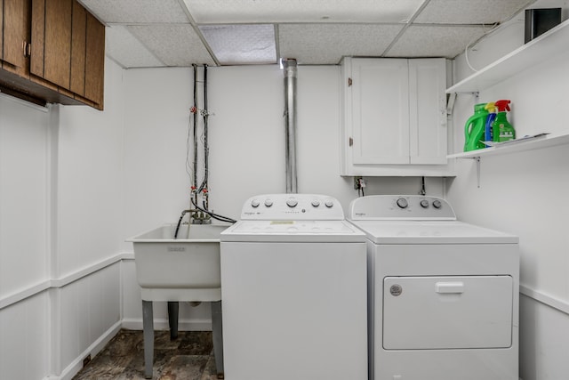 washroom with cabinet space and washer and dryer