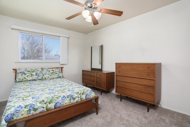 bedroom with ceiling fan, baseboards, and light carpet