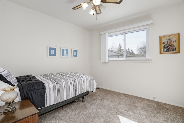 bedroom with baseboards, carpet floors, and a ceiling fan