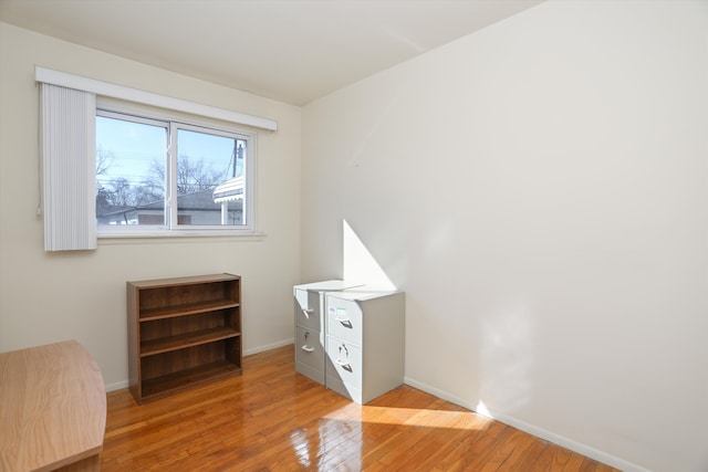 unfurnished bedroom with light wood-type flooring and baseboards