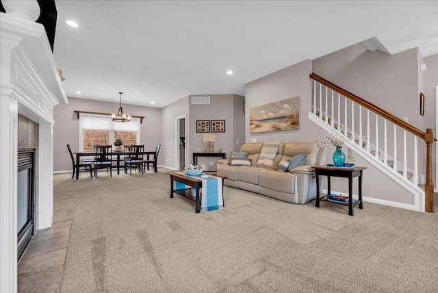 carpeted living room featuring visible vents, baseboards, stairs, a fireplace, and recessed lighting