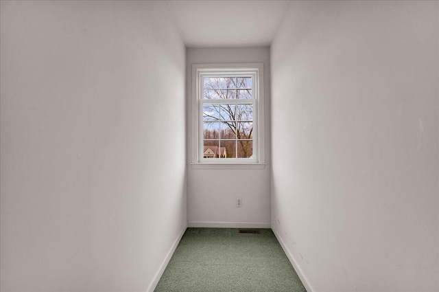 unfurnished room with light carpet and baseboards