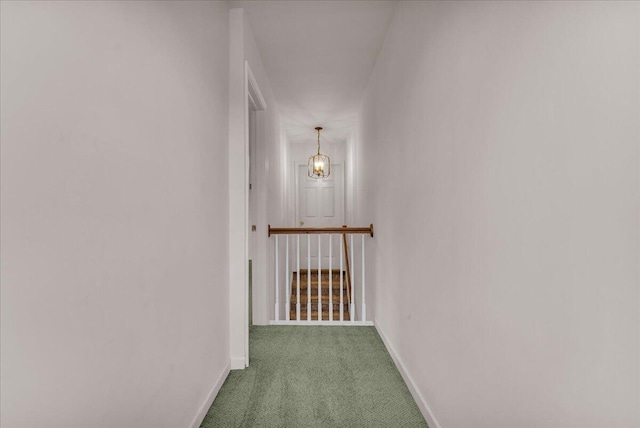 hall featuring carpet flooring and baseboards