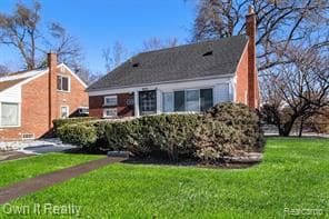 view of front of house featuring a chimney and a front yard