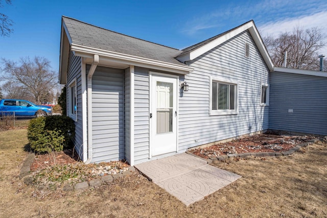 exterior space with a shingled roof