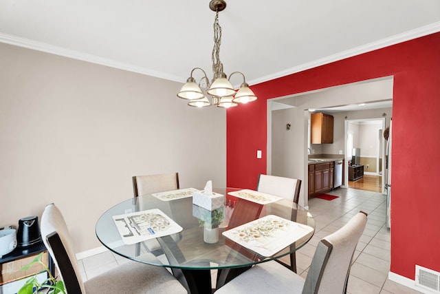 dining area with visible vents, crown molding, an inviting chandelier, and light tile patterned floors