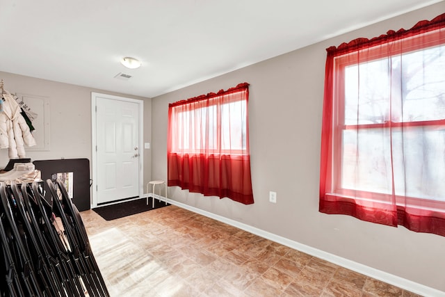 foyer with visible vents and baseboards