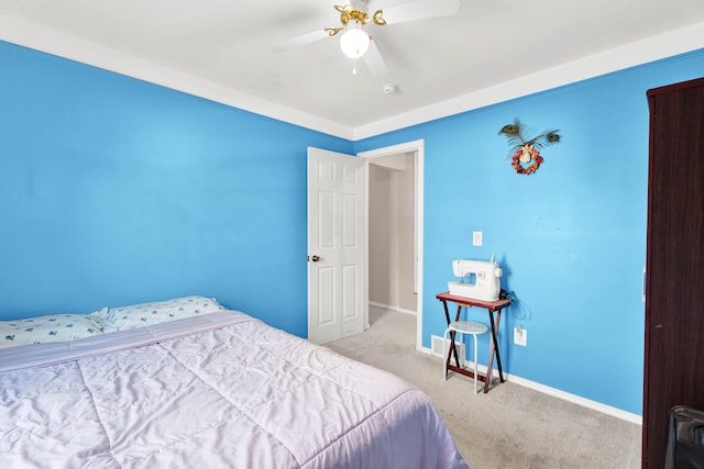 carpeted bedroom with ceiling fan and baseboards