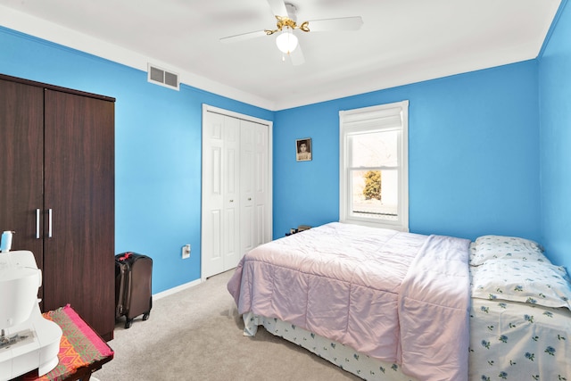 bedroom with light carpet, visible vents, baseboards, a ceiling fan, and a closet