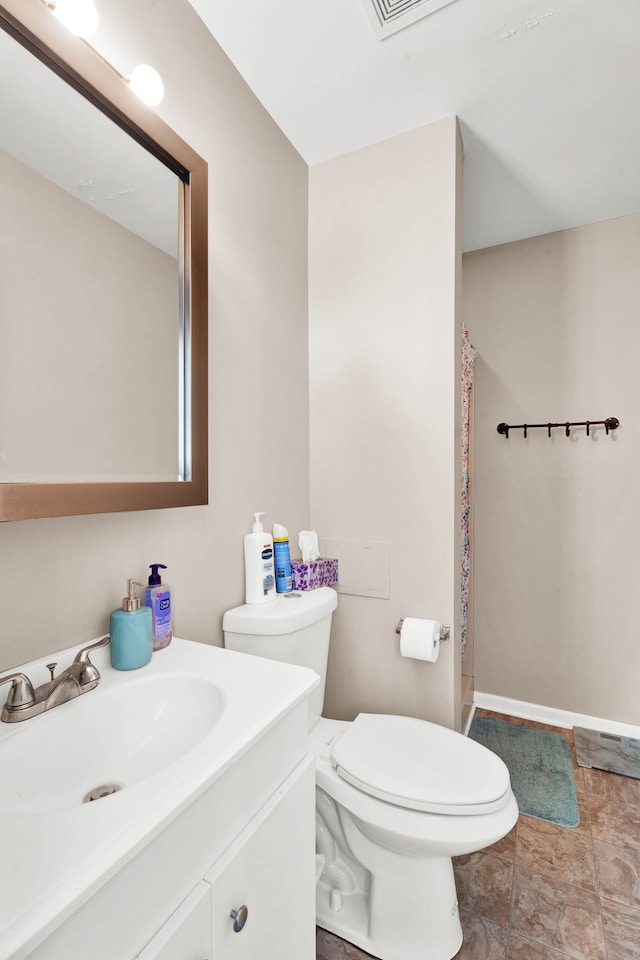 full bathroom featuring toilet, baseboards, and vanity