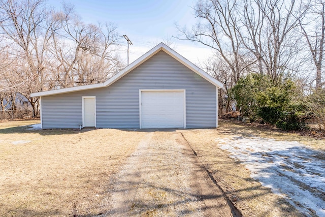 detached garage with dirt driveway