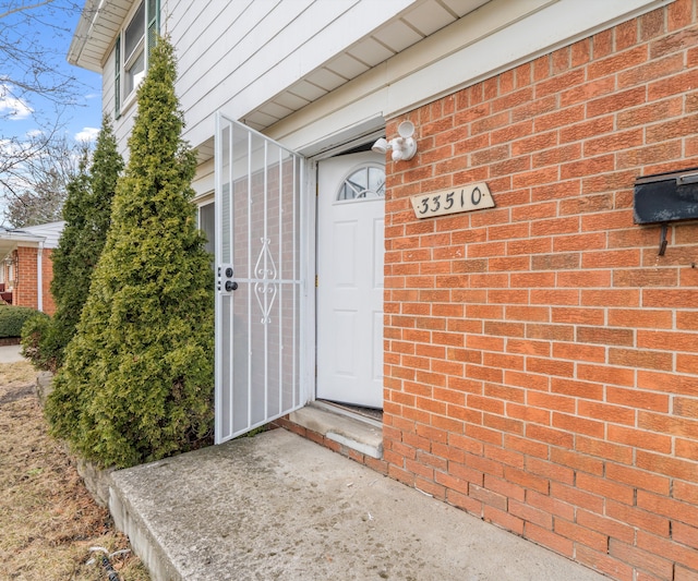 property entrance with brick siding