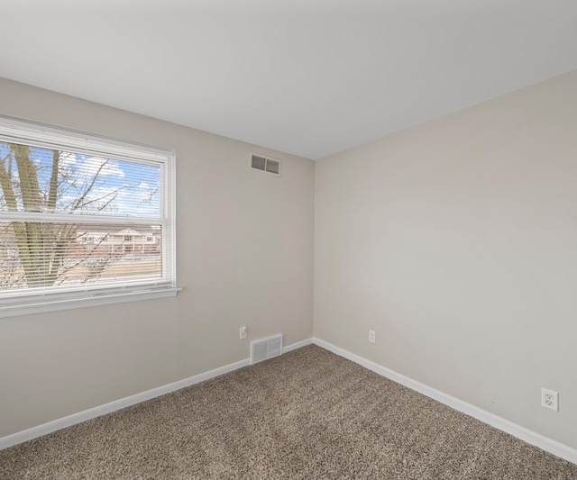 unfurnished room featuring carpet floors, baseboards, and visible vents