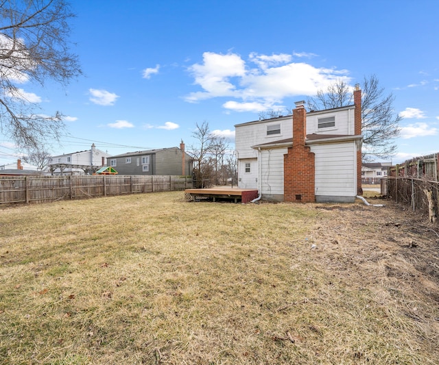 view of yard with a fenced backyard and a deck