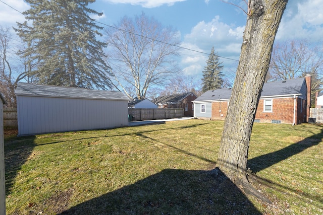 view of yard featuring an outdoor structure and fence