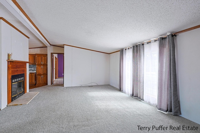 unfurnished living room featuring carpet, a fireplace with flush hearth, and crown molding