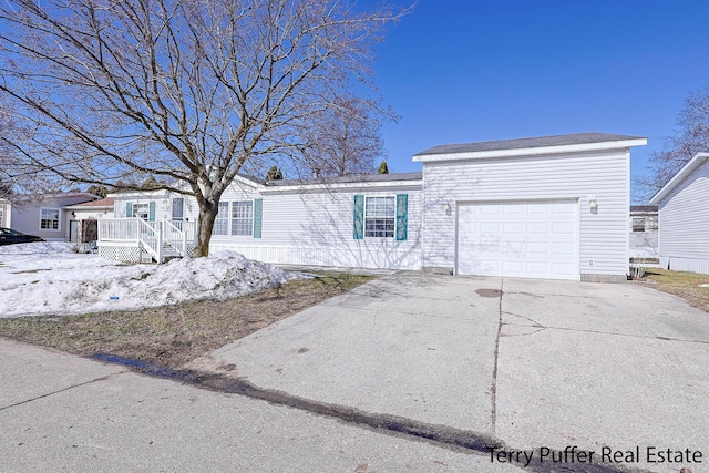 view of front of home with a garage and concrete driveway