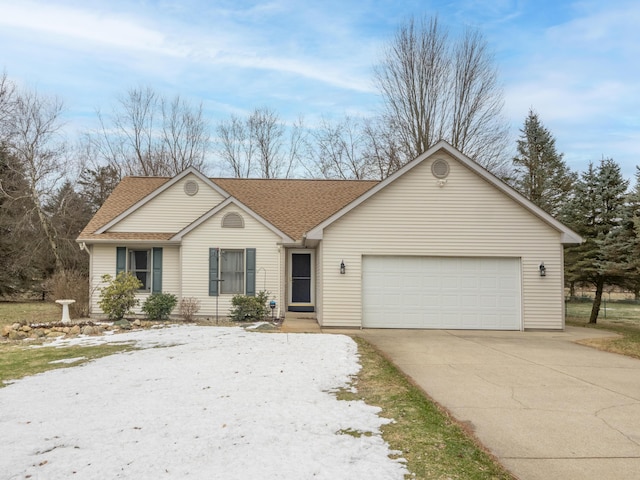 ranch-style home featuring a garage, concrete driveway, and a shingled roof