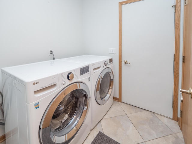 laundry area featuring washer and dryer, laundry area, and light tile patterned floors