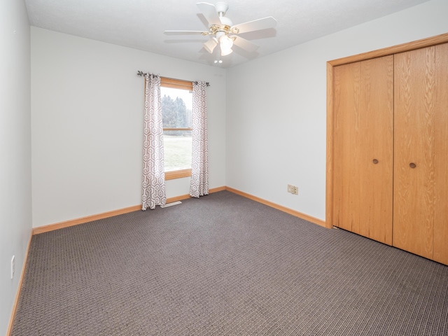 unfurnished bedroom featuring a closet, carpet flooring, ceiling fan, and baseboards