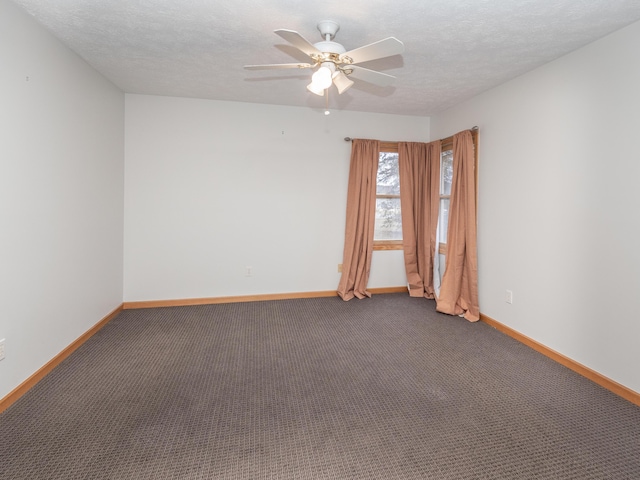 carpeted empty room featuring a textured ceiling, ceiling fan, and baseboards