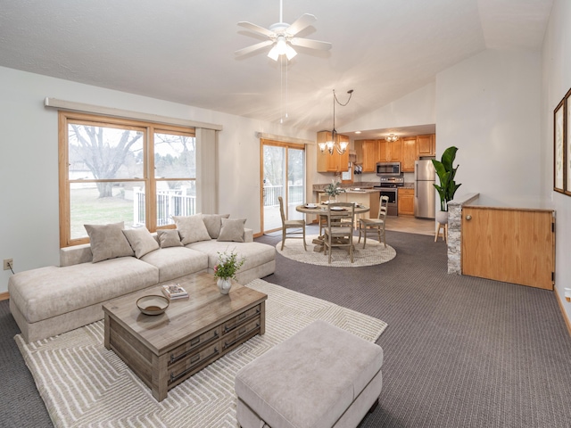 living room with carpet flooring, vaulted ceiling, and ceiling fan with notable chandelier