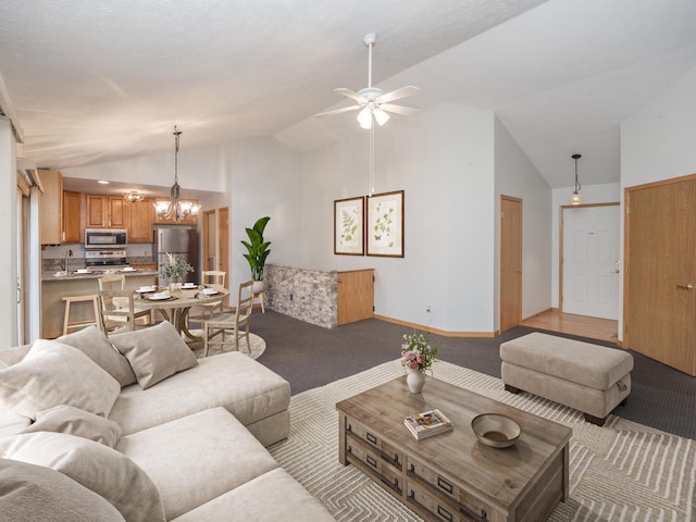 living room featuring light carpet, high vaulted ceiling, ceiling fan with notable chandelier, and baseboards