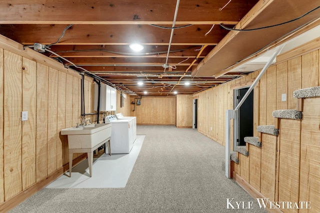 below grade area featuring light colored carpet and wooden walls