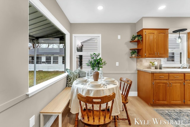 dining room with baseboards, light wood-style flooring, and recessed lighting