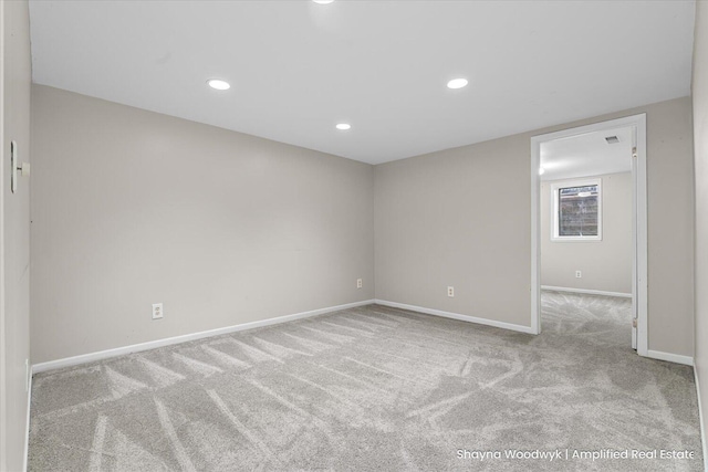 carpeted spare room with baseboards and recessed lighting