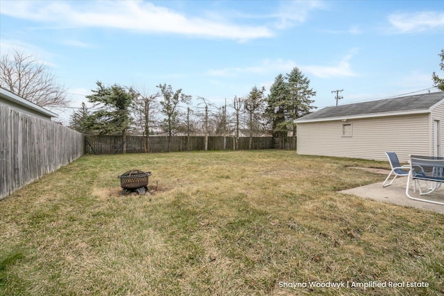 view of yard with a fire pit and a fenced backyard