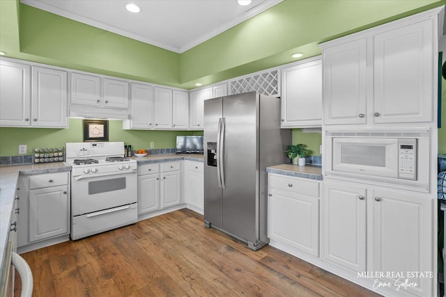 kitchen featuring dark wood-type flooring, white appliances, white cabinetry, and crown molding