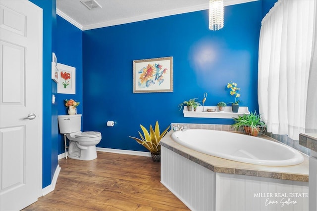 bathroom featuring toilet, wood finished floors, visible vents, ornamental molding, and a bath