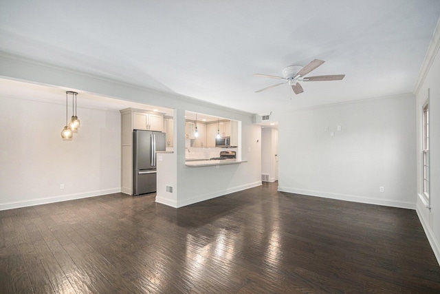 unfurnished living room with ceiling fan, dark wood-type flooring, visible vents, baseboards, and crown molding