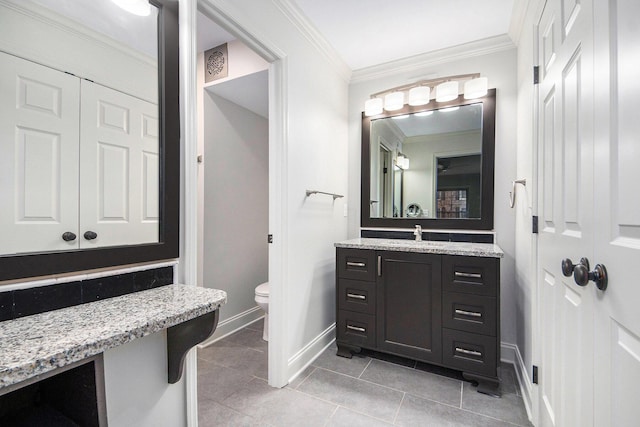 bathroom with baseboards, toilet, ornamental molding, tile patterned flooring, and vanity