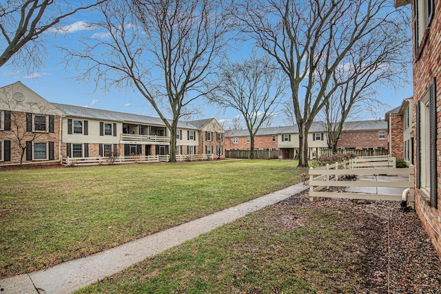 view of yard featuring fence and a residential view