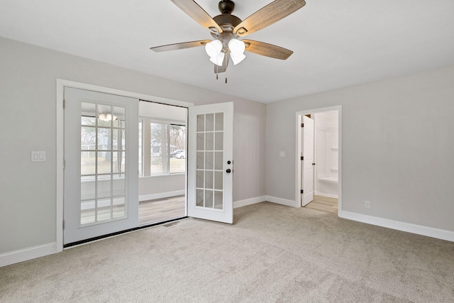 unfurnished room featuring french doors, carpet, a ceiling fan, and baseboards