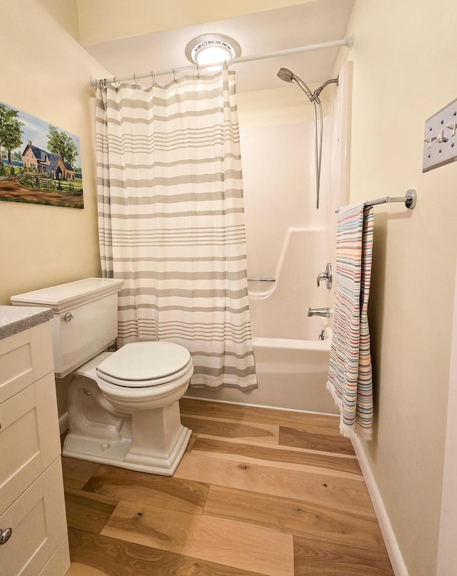 bathroom featuring shower / bath combo, vanity, toilet, and wood finished floors