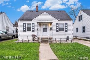 bungalow with a front lawn and a chimney