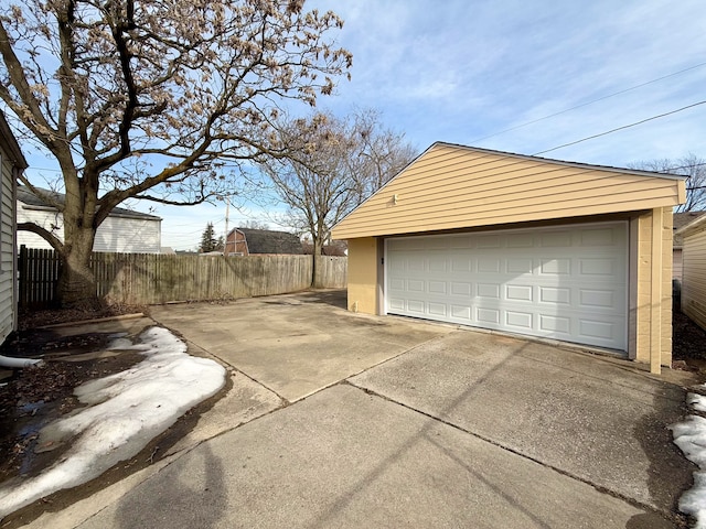 detached garage featuring fence